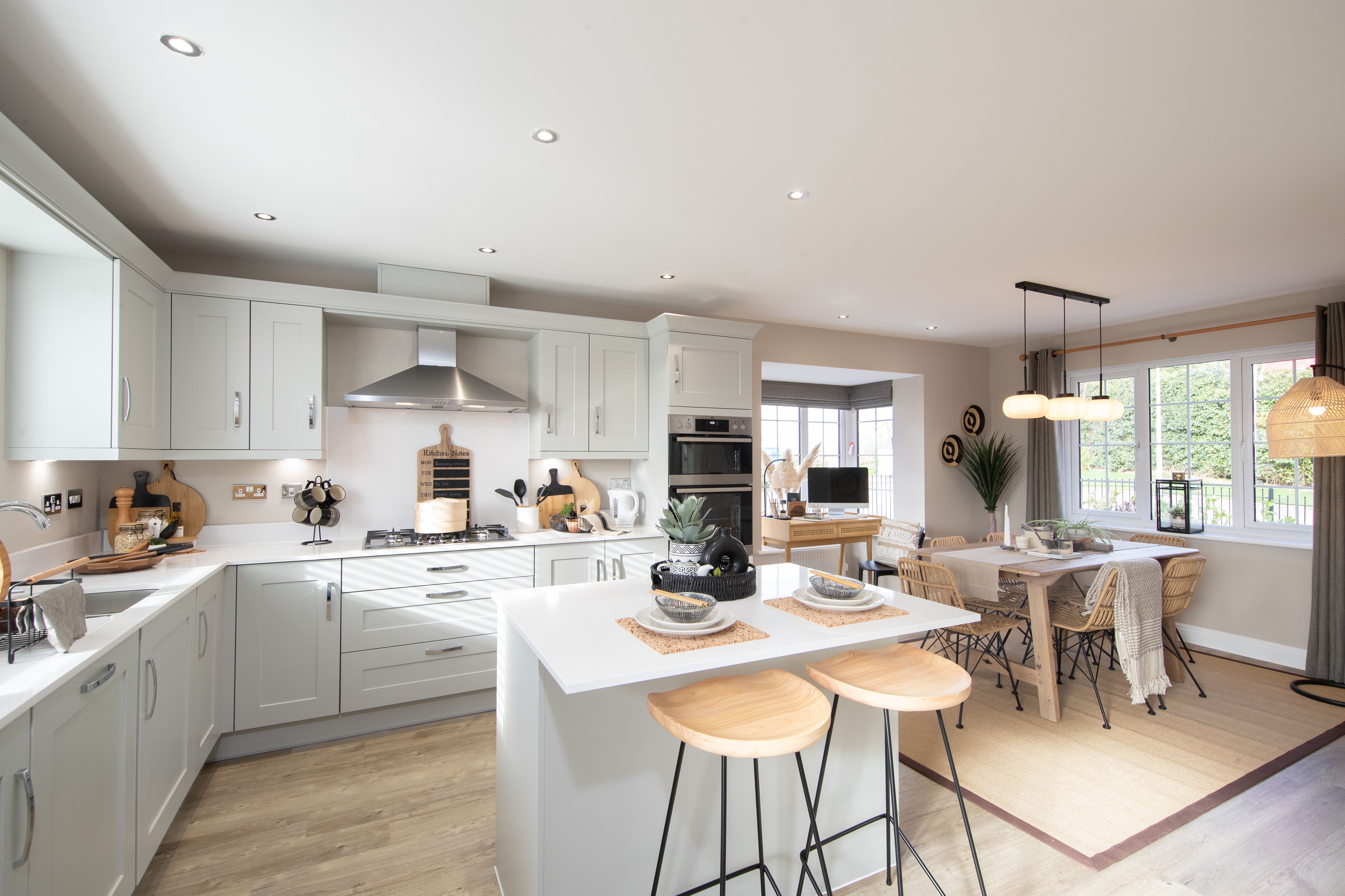 Large bright kitchen and dining room with white furniture in the Haversham house